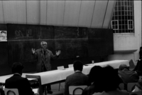 Alberto Cruz hablando a profesores y alumnos de la Escuela de Arquitectura y Diseño de la PUCV en el contexto del Acto del día de San Francisco, patrono de la Escuela