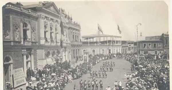 Brigadas de boy scouts desfilan en la plaza de Iquique, frente al Teatro Municipal, ca. 1920